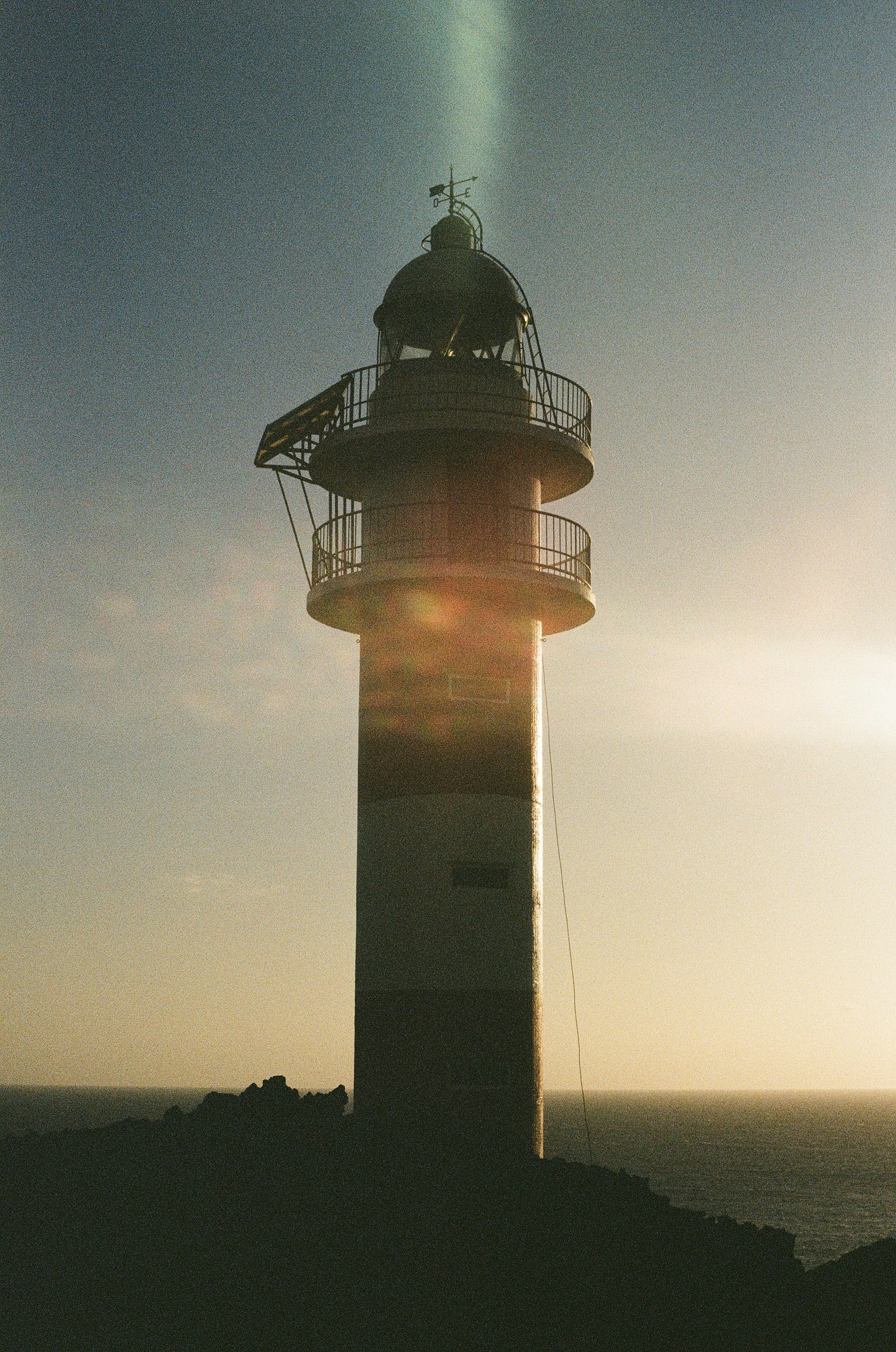 brown and black lighthouse under blue sky during daytime